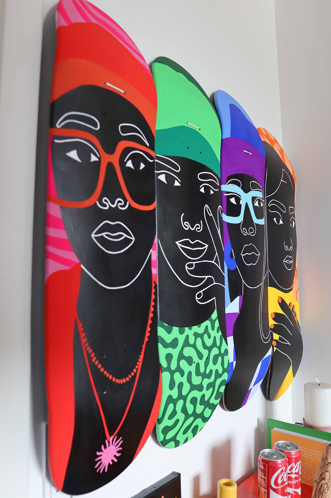 Colorful skateboard decks with artistic faces.